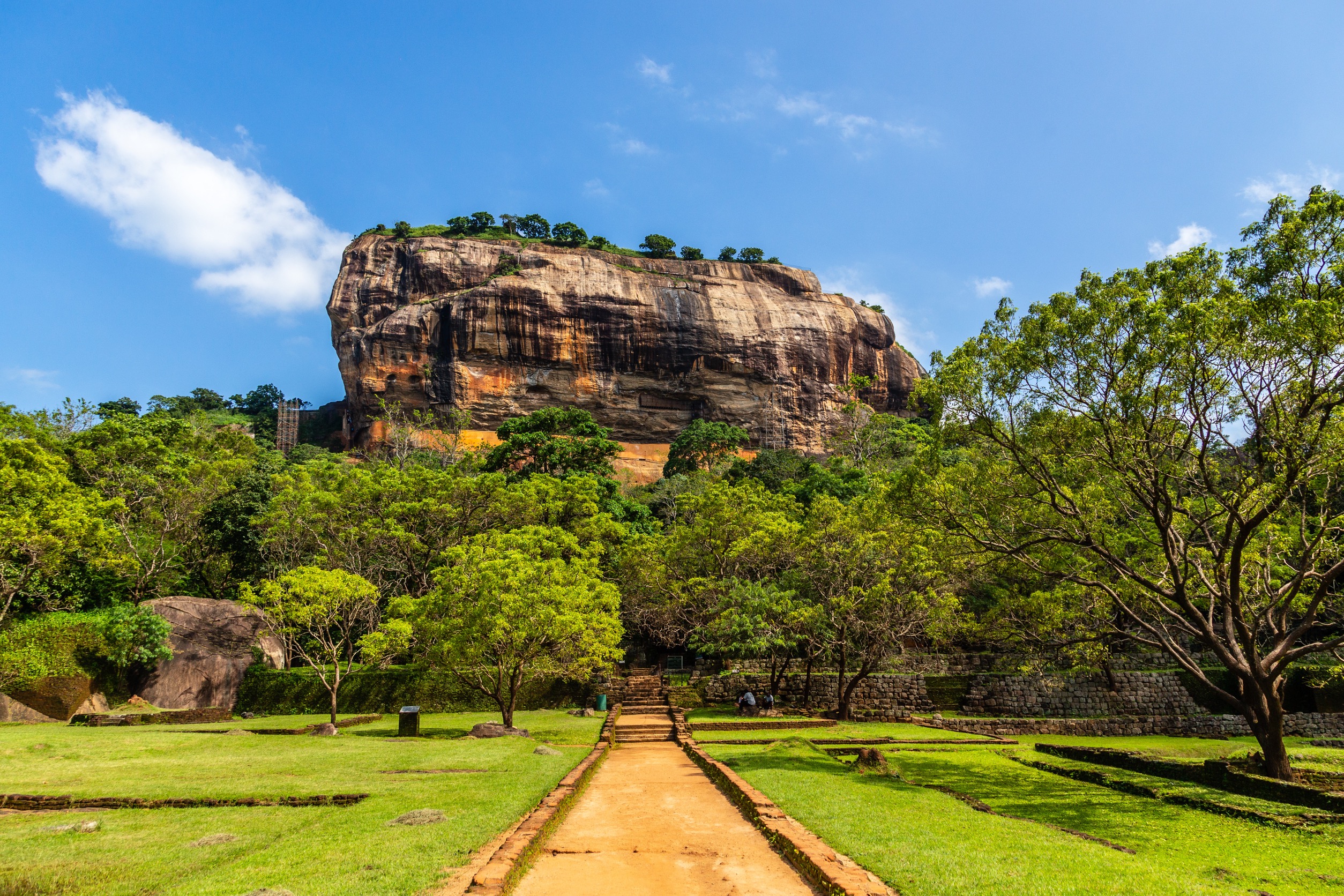 Sigiriya, also known as Lion Rock, is a 5th-century ancient rock fortress and palace complex rising roughly 180 meters (590 feet) above the surrounding plains in the Central Province of Sri Lanka.
